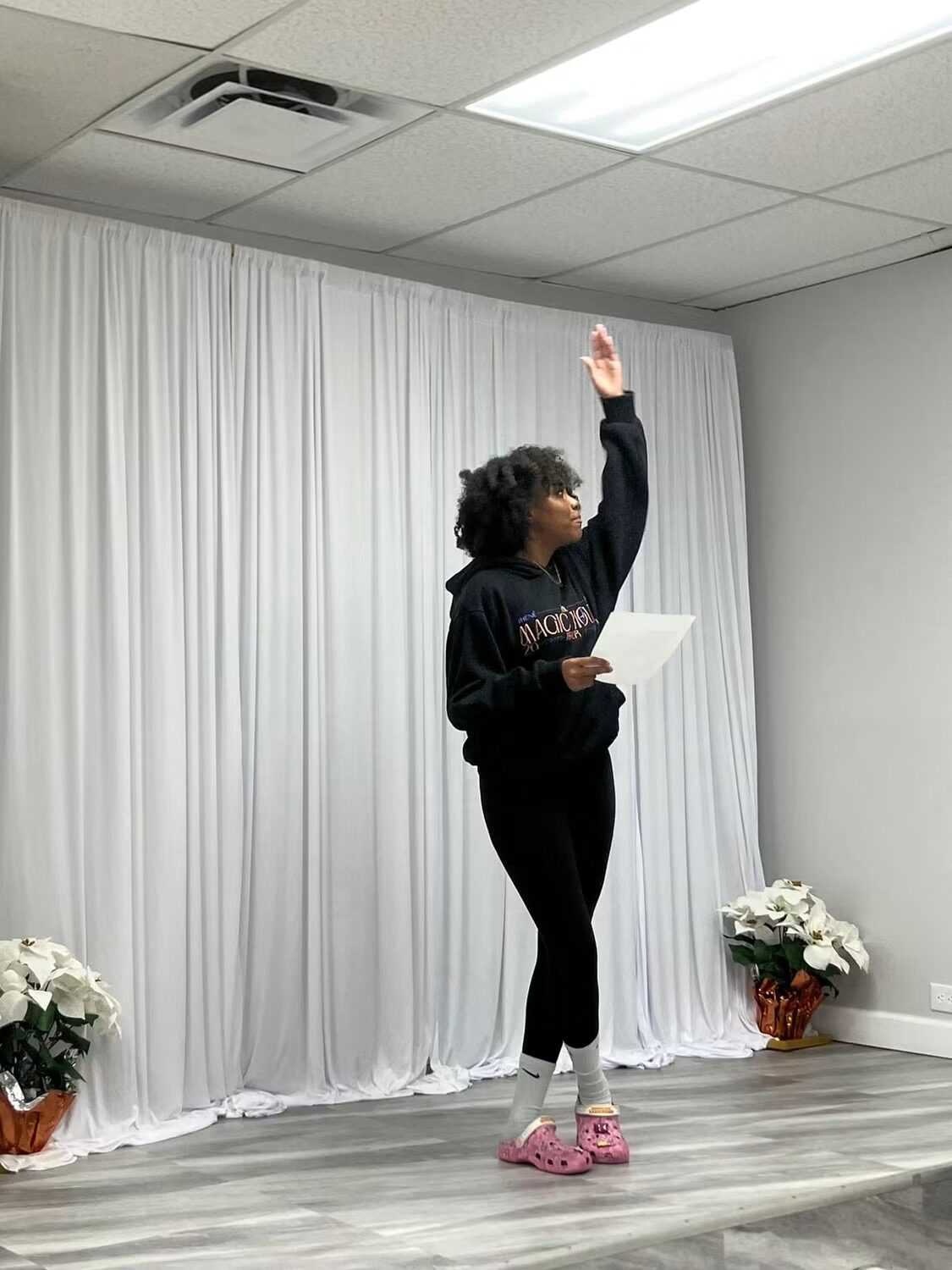 Student rehearsing a speech on stage